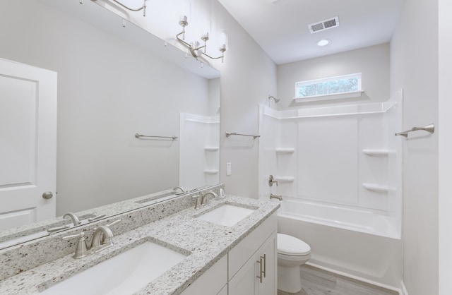 277 W Smith St, Lincolnville, SC 29485 - full bath featuring toilet, double vanity, wood finished floors, and shower / washtub combination
