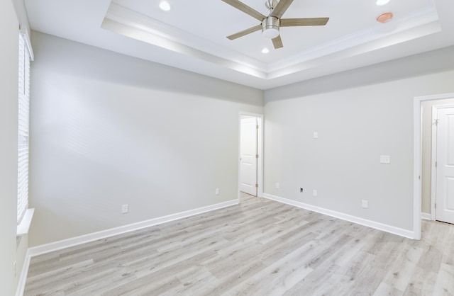 277 W Smith St, Lincolnville, SC 29485 - unfurnished room with a raised ceiling, crown molding, light wood-style floors, ceiling fan, and recessed lighting