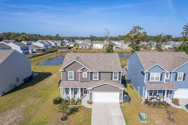 view of front of property with a water view and a garage