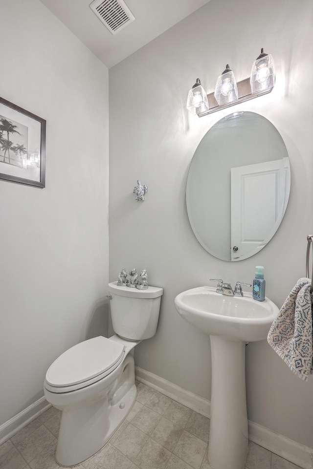 bathroom with tile patterned flooring and toilet