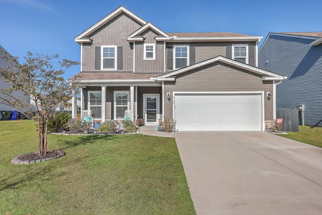 view of front facade featuring a front lawn, covered porch, and a garage