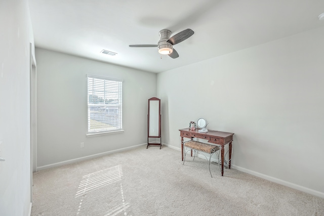 spare room with light colored carpet and ceiling fan