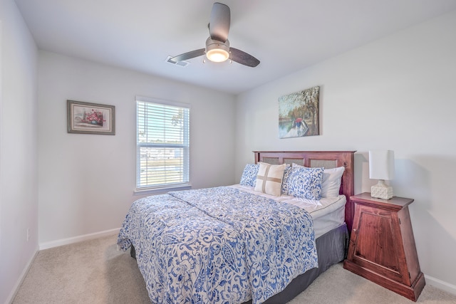 bedroom with ceiling fan and light carpet