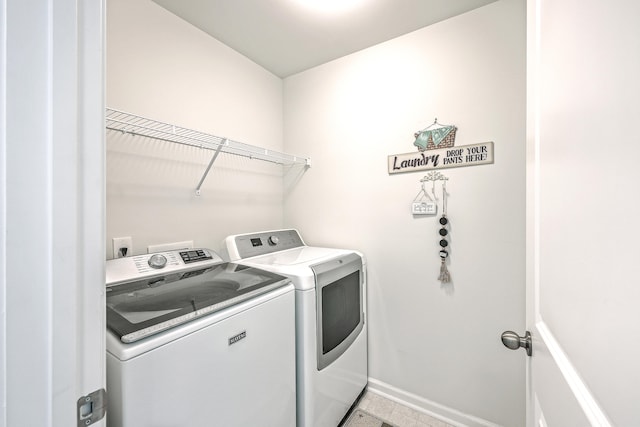 washroom featuring light tile patterned floors and separate washer and dryer