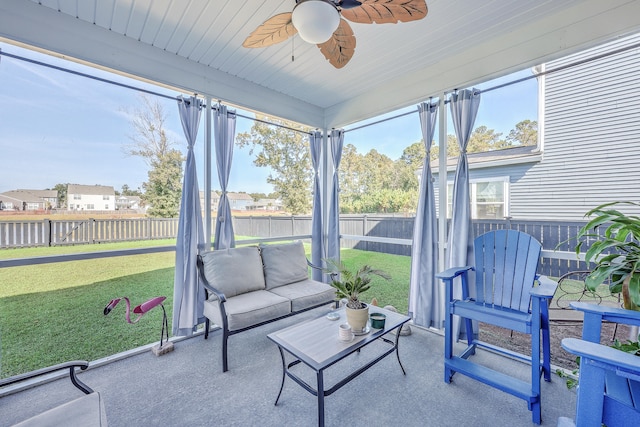 sunroom featuring ceiling fan and wooden ceiling