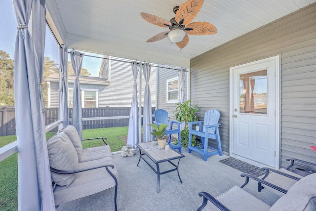 sunroom featuring ceiling fan