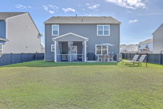 rear view of house with a lawn and a patio