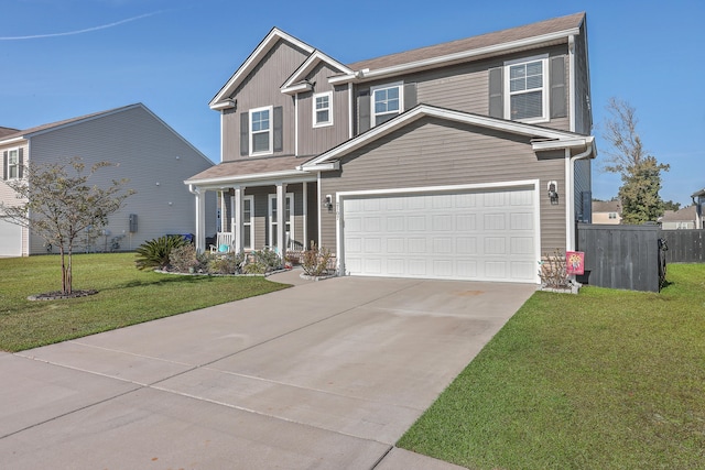 view of front of house featuring a front yard, a porch, and a garage