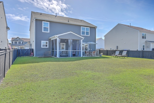 back of property featuring a yard and a sunroom