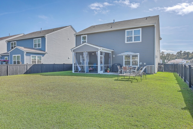 back of house with a lawn and a sunroom