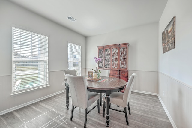 dining space featuring a wealth of natural light and hardwood / wood-style flooring