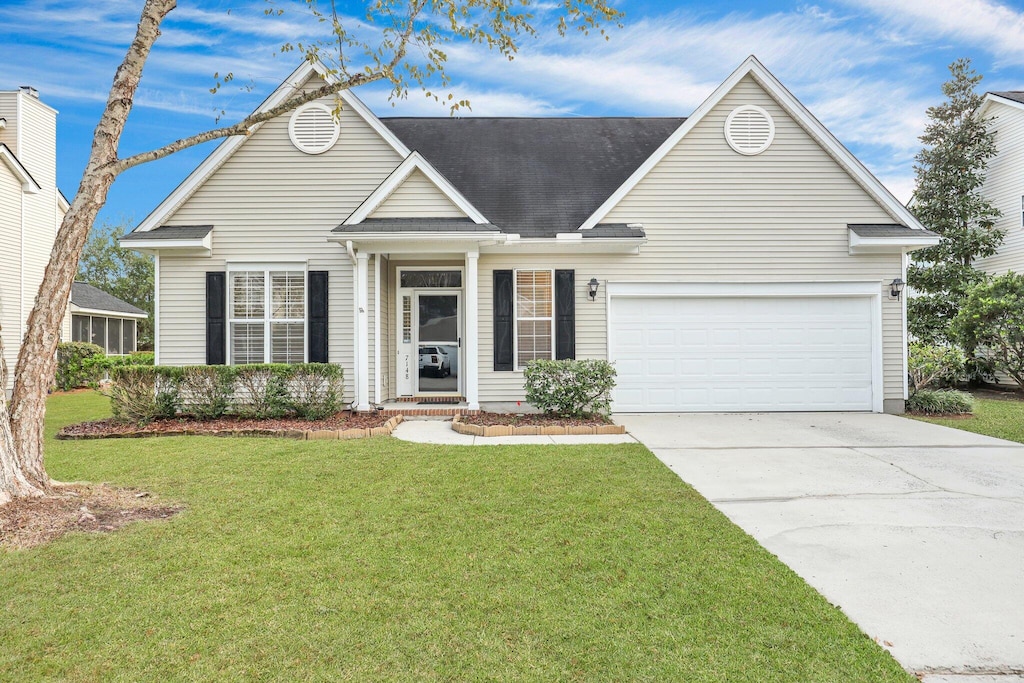 view of front of house featuring a garage and a front lawn