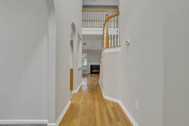 corridor with light hardwood / wood-style flooring