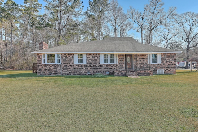 ranch-style home with a front yard, central air condition unit, brick siding, and a chimney