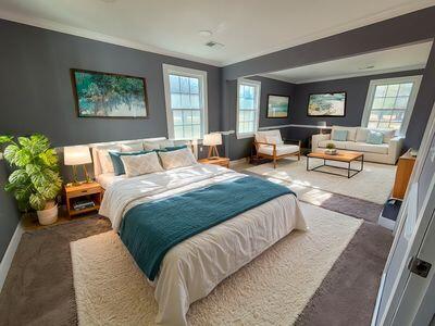 bedroom with multiple windows, ornamental molding, and carpet flooring