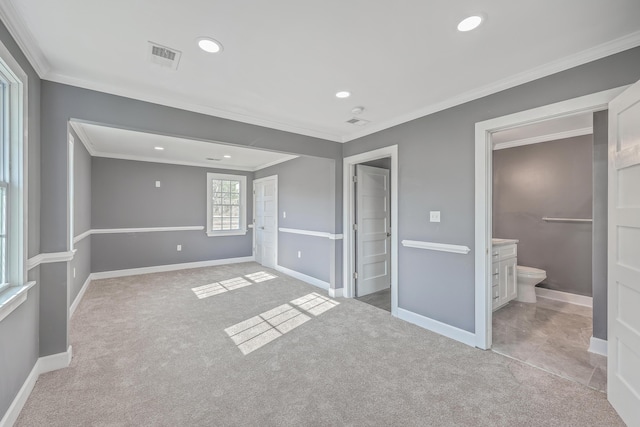 unfurnished bedroom featuring crown molding, visible vents, baseboards, and light carpet