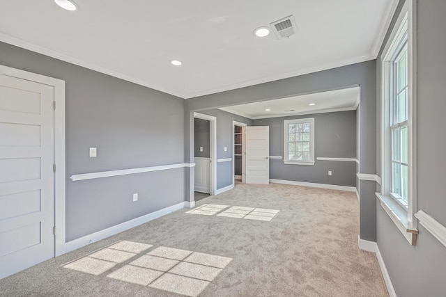 unfurnished bedroom with visible vents, baseboards, carpet, and ornamental molding