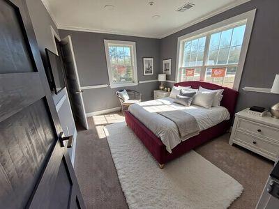 bedroom featuring visible vents, crown molding, and carpet