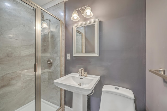 bathroom with a shower stall and toilet