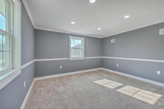 spare room with visible vents, baseboards, carpet floors, and ornamental molding