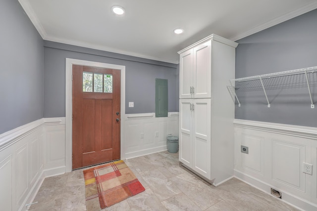 interior space with recessed lighting, a wainscoted wall, ornamental molding, and a decorative wall