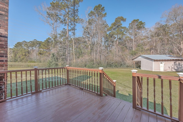 wooden deck featuring an outbuilding and a yard