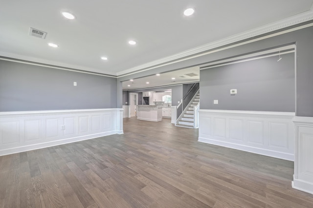 interior space with stairway, wood finished floors, visible vents, recessed lighting, and crown molding