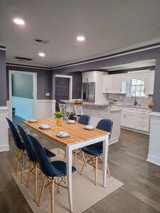 dining room featuring dark wood-style floors, recessed lighting, and wainscoting