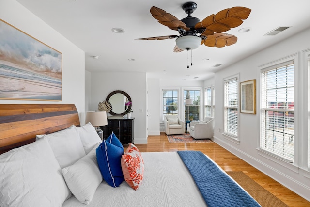 bedroom with light hardwood / wood-style flooring and ceiling fan