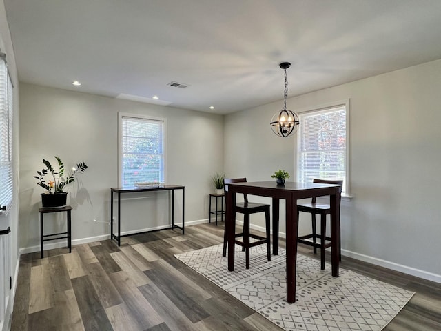 dining area with wood finished floors, visible vents, and a healthy amount of sunlight