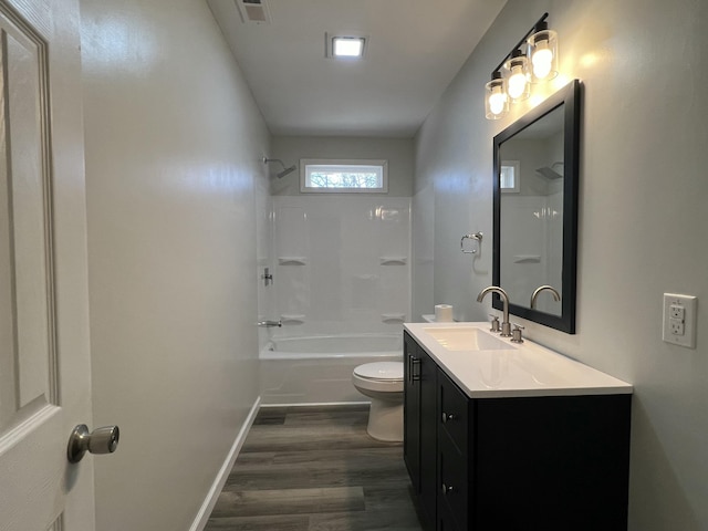 full bath with visible vents, toilet, shower / bathing tub combination, wood finished floors, and vanity