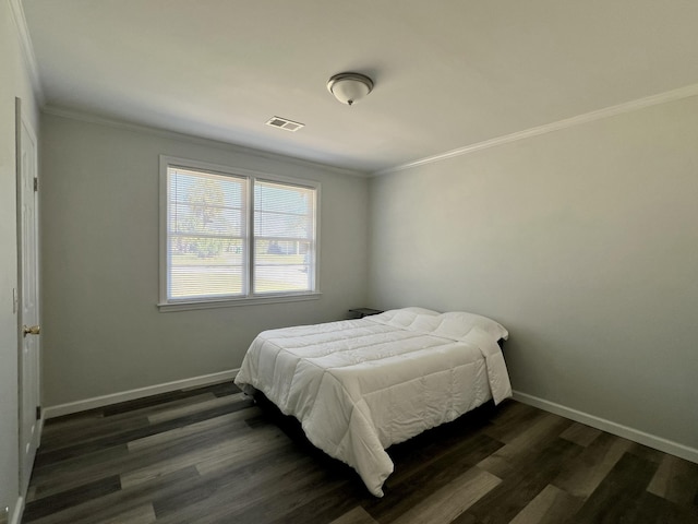 bedroom with visible vents, ornamental molding, and dark wood-style flooring