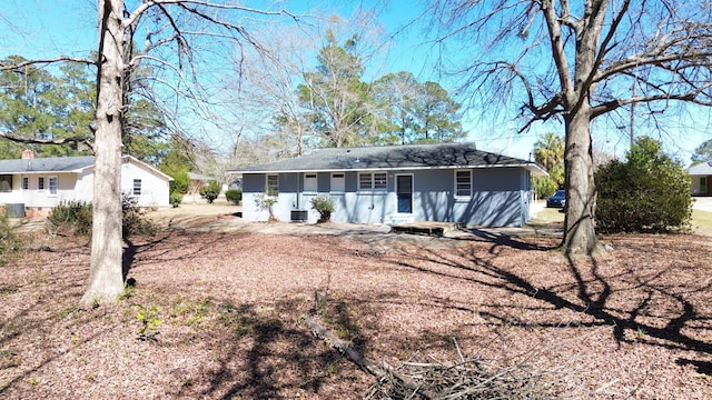 back of property featuring central AC