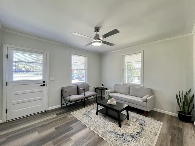 living area featuring a wealth of natural light, dark wood-style floors, and ornamental molding