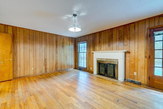 5322 Chantilly Ln, North Charleston, SC 29418 - unfurnished living room with wood finished floors, plenty of natural light, and wood walls