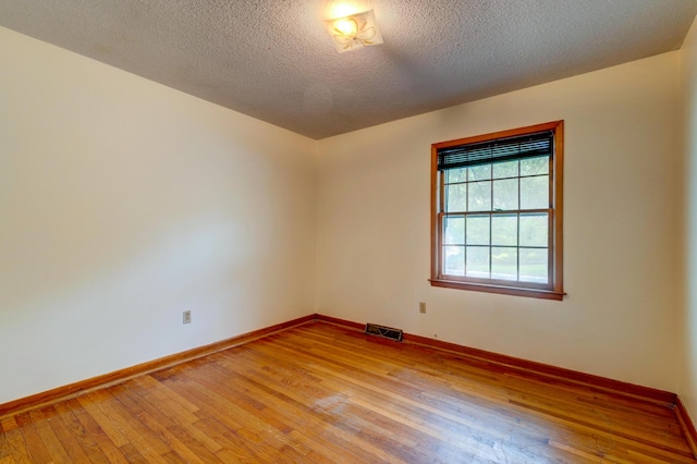 5322 Chantilly Ln, North Charleston, SC 29418 - unfurnished room featuring light wood finished floors, baseboards, and a textured ceiling