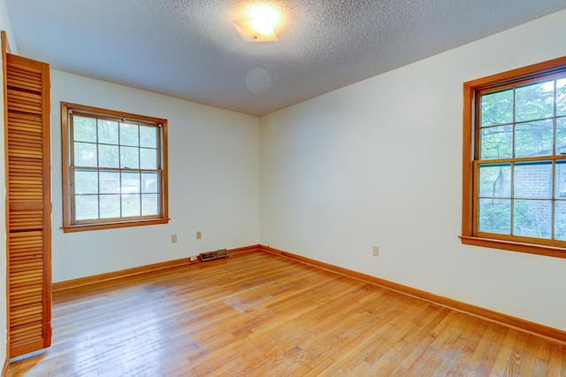 5322 Chantilly Ln, North Charleston, SC 29418 - empty room featuring light wood-style flooring, a textured ceiling, and baseboards