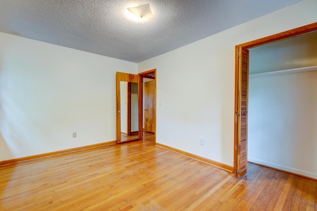 5322 Chantilly Ln, North Charleston, SC 29418 - unfurnished bedroom featuring light wood-style floors, a closet, baseboards, and a textured ceiling
