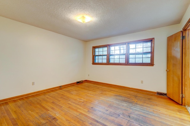 5322 Chantilly Ln, North Charleston, SC 29418 - unfurnished bedroom with light wood-type flooring, baseboards, and a textured ceiling