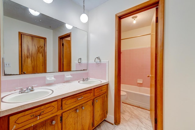 5322 Chantilly Ln, North Charleston, SC 29418 - full bathroom featuring double vanity, toilet, washtub / shower combination, and decorative backsplash
