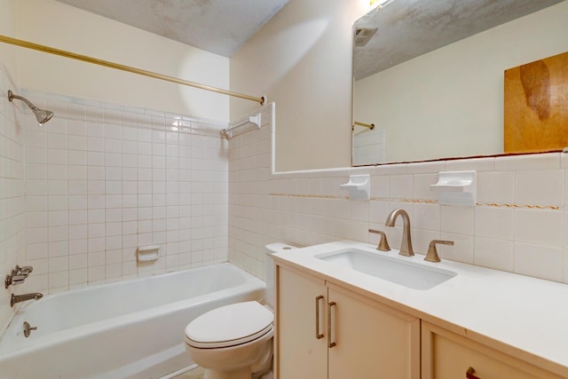 5322 Chantilly Ln, North Charleston, SC 29418 - bathroom featuring toilet, bathtub / shower combination, vanity, tile walls, and a textured ceiling