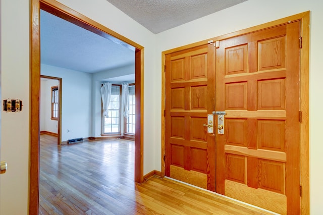 5322 Chantilly Ln, North Charleston, SC 29418 - entrance foyer featuring wood finished floors, baseboards, and a textured ceiling