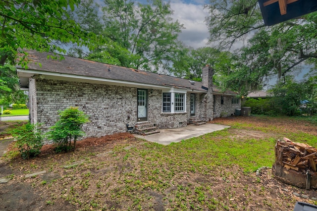 5322 Chantilly Ln, North Charleston, SC 29418 - back of house with entry steps, a chimney, a patio area, brick siding, and crawl space