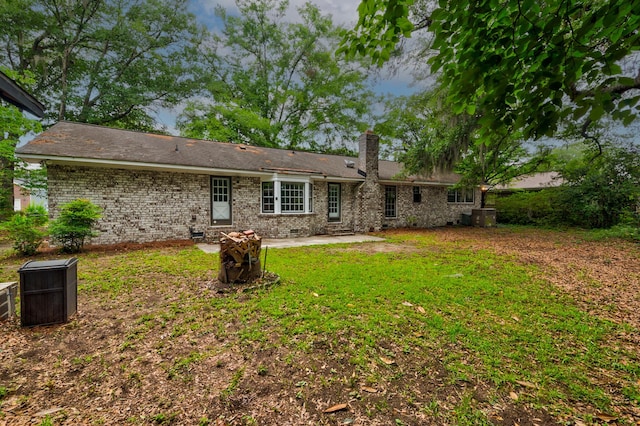 5322 Chantilly Ln, North Charleston, SC 29418 - back of property with a chimney, a patio area, crawl space, brick siding, and a yard