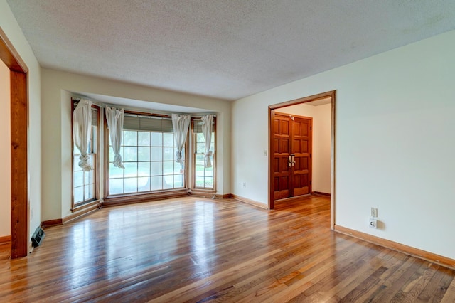 5322 Chantilly Ln, North Charleston, SC 29418 - unfurnished room featuring wood finished floors, a textured ceiling, and baseboards
