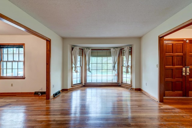 5322 Chantilly Ln, North Charleston, SC 29418 - unfurnished room featuring wood finished floors, baseboards, and a textured ceiling