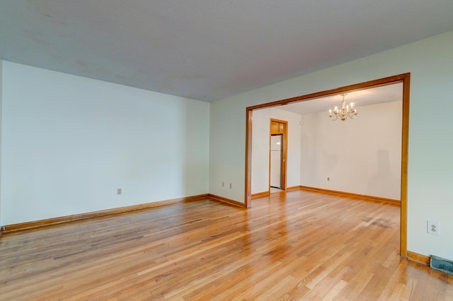 5322 Chantilly Ln, North Charleston, SC 29418 - unfurnished room with a chandelier, light wood-style floors, and baseboards