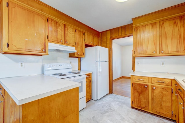 5322 Chantilly Ln, North Charleston, SC 29418 - kitchen with under cabinet range hood, white appliances, light countertops, and brown cabinetry