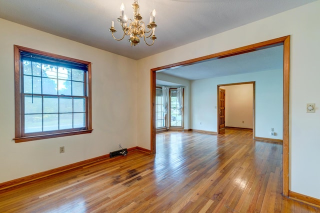 5322 Chantilly Ln, North Charleston, SC 29418 - unfurnished room with a chandelier, healthy amount of natural light, and hardwood / wood-style flooring