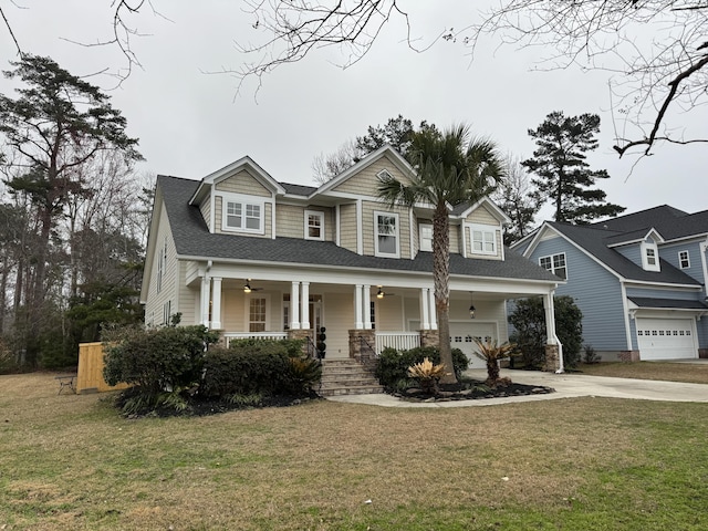 view of front of home featuring a garage, a front yard, and a porch